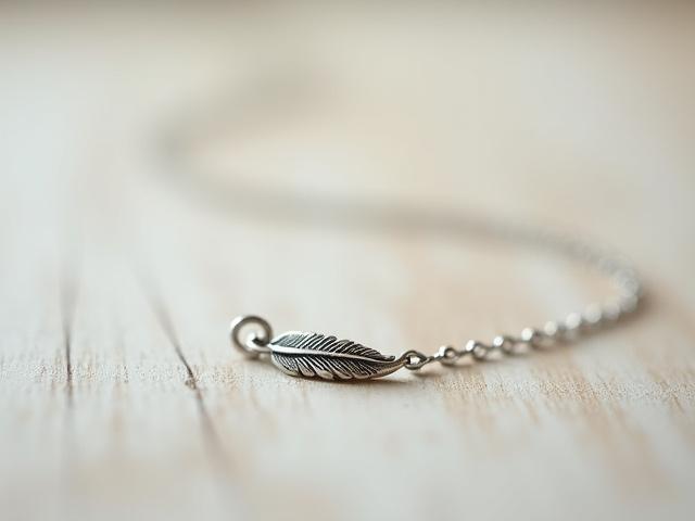 Dainty sterling silver necklace with a finely detailed feather charm, bohemian style