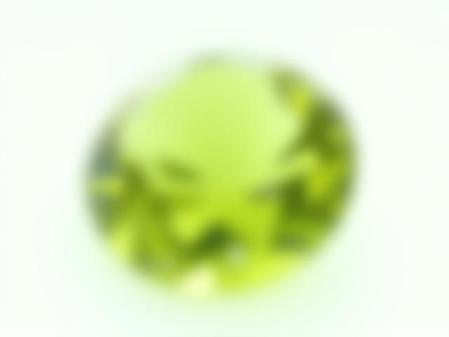 A brilliant, olive-green faceted peridot gemstone, shimmering with light.